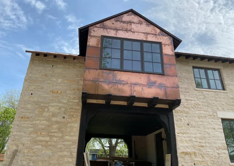 Copper metal panel facade on a stone building for Metal Roof Coating in Neosho